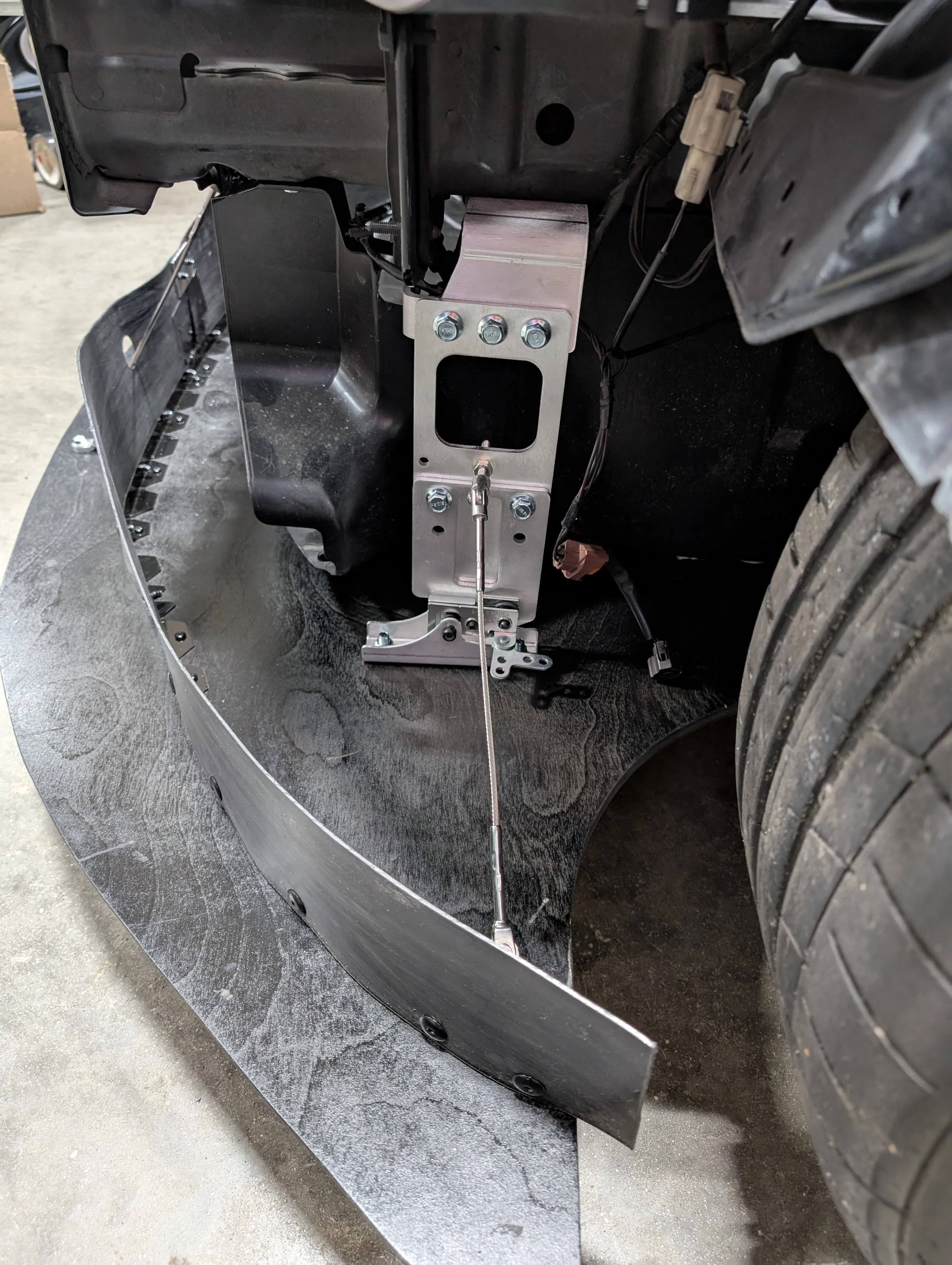 Splitter mount installed under the front chassis rail